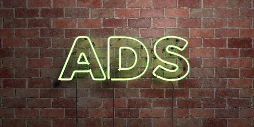 ADS - fluorescent Neon tube Sign on brickwork - Front view - 3D rendered royalty free stock picture. Can be used for online banner ads and direct mailers.