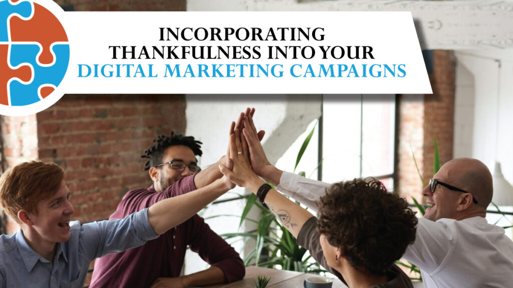 Group of four people sitting at a table high-fiving. Text reads, "Incorporating Thankfulness into Your Digital Marketing Campaigns.