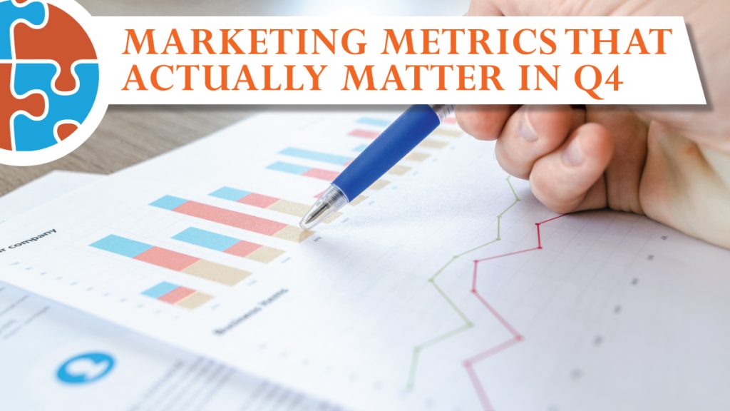 A hand holds a pen over printed charts and graphs, with text reading "Marketing Metrics That Actually Matter in Q4" displayed at the top of the image.