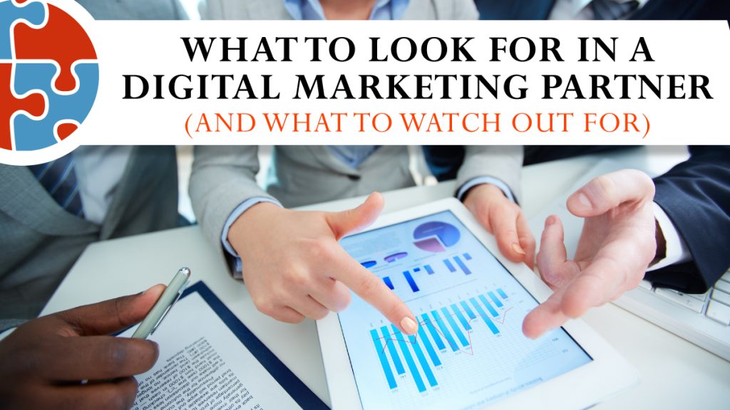 Three people in business attire discuss charts on a tablet. Text overlay reads: “What to look for in a digital marketing partner (and what to watch out for).”.